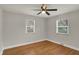 Bright bedroom featuring hardwood floors, neutral paint, ceiling fan, and natural light from two windows at 4775 E 56Th St, Indianapolis, IN 46220