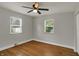 Spacious bedroom features hardwood floors, neutral paint, ceiling fan, and lots of natural light at 4775 E 56Th St, Indianapolis, IN 46220