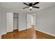 Bedroom with hardwood floors, freshly painted walls, ceiling fan, and closet space at 4775 E 56Th St, Indianapolis, IN 46220