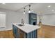 Well-lit kitchen island with stainless steel dishwasher, hardwood floors, and view of the fireplace at 4775 E 56Th St, Indianapolis, IN 46220