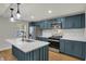 Stylish kitchen featuring stainless steel appliances, shaker cabinets, and a quartz countertop island at 4775 E 56Th St, Indianapolis, IN 46220