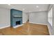 Spacious living room featuring hardwood floors and a striking painted brick fireplace at 4775 E 56Th St, Indianapolis, IN 46220