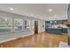 Bright living room with hardwood floors and a view of the kitchen featuring modern appliances at 4775 E 56Th St, Indianapolis, IN 46220