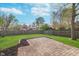 Large backyard featuring lush green grass, brick patio, and privacy fence perfect for entertaining at 4917 Melbourne Rd, Indianapolis, IN 46228