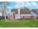 Spacious backyard with a lush lawn, a brick paver patio, wood deck and shed perfect for outdoor living at 4917 Melbourne Rd, Indianapolis, IN 46228