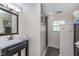 Bathroom with a modern vanity, large mirror, and walk-in shower at 4917 Melbourne Rd, Indianapolis, IN 46228
