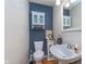 Stylish half bathroom features a modern sink, decorative mirror, and accent wall at 4917 Melbourne Rd, Indianapolis, IN 46228