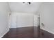 The bedroom has a vaulted ceiling, dark hardwood floors, and natural light at 4917 Melbourne Rd, Indianapolis, IN 46228