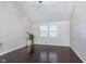 The bedroom has a vaulted ceiling, dark hardwood floors, and natural light at 4917 Melbourne Rd, Indianapolis, IN 46228