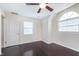 Bedroom featuring hardwood floors, ceiling fan, and ample natural light creating a bright atmosphere at 4917 Melbourne Rd, Indianapolis, IN 46228