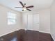 Bright bedroom with hardwood floors, ceiling fan, and double door closet providing comfort and style at 4917 Melbourne Rd, Indianapolis, IN 46228