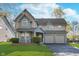 Charming two-story home with a well-manicured lawn and a two-car garage at 4917 Melbourne Rd, Indianapolis, IN 46228