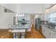 Bright kitchen features an island with seating, stainless steel appliances, and gray cabinets at 4917 Melbourne Rd, Indianapolis, IN 46228