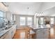 Bright kitchen with granite countertops, an island, and hardwood floors at 4917 Melbourne Rd, Indianapolis, IN 46228