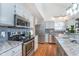 The kitchen has stainless steel appliances, granite countertops and gray cabinets at 4917 Melbourne Rd, Indianapolis, IN 46228