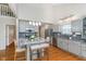 Bright kitchen features an island with seating, stainless steel appliances, and gray cabinets at 4917 Melbourne Rd, Indianapolis, IN 46228