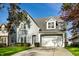 Traditional home with a gable roof, dormer windows, attached garage, and mature trees at 5034 N Illinois St, Indianapolis, IN 46208