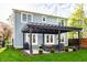 Outdoor living with a shaded pergola, stylish seating, and landscaped garden in a serene backyard setting at 5034 N Illinois St, Indianapolis, IN 46208