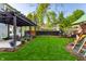 Expansive backyard showcasing a patio, lush lawn, mature trees, a playset and trampoline creating a fun space at 5034 N Illinois St, Indianapolis, IN 46208