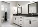 Bathroom featuring double vanity with black countertops, black framed mirrors and hexagon tile floor at 5034 N Illinois St, Indianapolis, IN 46208