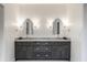 Bathroom featuring double vanity with gray cabinets, marble countertop and hexagon tile floor at 5034 N Illinois St, Indianapolis, IN 46208