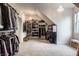 Large walk-in closet with custom shelving, carpeted floor, chandelier lighting and a window at 5034 N Illinois St, Indianapolis, IN 46208