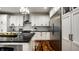 A modern kitchen features a stainless steel refrigerator, white cabinetry and a black countertop island at 5034 N Illinois St, Indianapolis, IN 46208