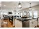 A modern open concept kitchen and dining area features wood floors, and stainless steel appliances at 5034 N Illinois St, Indianapolis, IN 46208