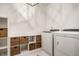 Bright laundry room featuring a modern washer and dryer, white cabinets, and stylish woven storage baskets at 5034 N Illinois St, Indianapolis, IN 46208