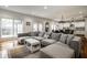 Open-concept space featuring hardwood floors, a large sectional sofa, and combined dining and living areas at 5034 N Illinois St, Indianapolis, IN 46208