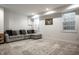 Cozy living room with a comfortable gray sectional sofa, patterned rug, and natural light from the windows at 5034 N Illinois St, Indianapolis, IN 46208