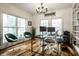 Sunlit office featuring large windows, a dark wood desk, and green velvet chairs at 5034 N Illinois St, Indianapolis, IN 46208