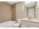 Bathroom featuring a tiled shower and bath, and vanity with sink and mirror at 5212 Knollton Rd, Indianapolis, IN 46228