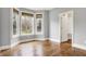 Sunlit bedroom with hardwood floors, large bay windows, and a walk-in closet for ample storage at 5212 Knollton Rd, Indianapolis, IN 46228