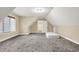 Attic bedroom featuring plush carpeting and natural light, creating a cozy and inviting space at 5212 Knollton Rd, Indianapolis, IN 46228