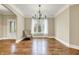 Bright dining room featuring hardwood floors, a chandelier, and large window at 5212 Knollton Rd, Indianapolis, IN 46228