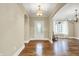 Inviting entryway featuring hardwood floors, an arched doorway, and a chandelier at 5212 Knollton Rd, Indianapolis, IN 46228