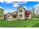 Beautiful backyard featuring a well-manicured lawn and stone fireplace at 5212 Knollton Rd, Indianapolis, IN 46228