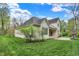 Backyard view of home featuring a well-manicured lawn and stone fireplace at 5212 Knollton Rd, Indianapolis, IN 46228