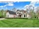 Charming two-story home with a well-manicured lawn and beautiful landscaping at 5212 Knollton Rd, Indianapolis, IN 46228