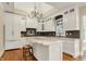 Modern kitchen featuring white cabinets, a center island with marble countertops, and stainless appliances at 5212 Knollton Rd, Indianapolis, IN 46228