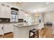 Bright kitchen with white cabinets, granite countertops, large island with seating, and stainless steel appliances at 5212 Knollton Rd, Indianapolis, IN 46228