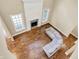 Open-concept living room with a fireplace, hardwood floors, and abundant natural light at 5212 Knollton Rd, Indianapolis, IN 46228