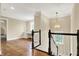 Loft featuring wood floors and black and white stairs in a naturally lit home at 5212 Knollton Rd, Indianapolis, IN 46228