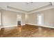 Spacious main bedroom featuring a tray ceiling, hardwood floors, and an en-suite bathroom with separate vanities at 5212 Knollton Rd, Indianapolis, IN 46228