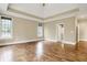 Large main bedroom with hardwood floors, tray ceiling, natural light and neutral paint tones at 5212 Knollton Rd, Indianapolis, IN 46228