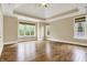 Expansive main bedroom featuring hardwood floors, tray ceilings, and large windows offering natural light at 5212 Knollton Rd, Indianapolis, IN 46228