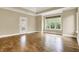 Bright main bedroom with hardwood floors, tray ceiling, large window and glass door at 5212 Knollton Rd, Indianapolis, IN 46228