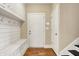 Inviting mudroom with built-in bench, storage cabinets, and convenient access to the home's entrance at 5212 Knollton Rd, Indianapolis, IN 46228