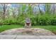 View of the stone fireplace and patio in the backyard at 5212 Knollton Rd, Indianapolis, IN 46228